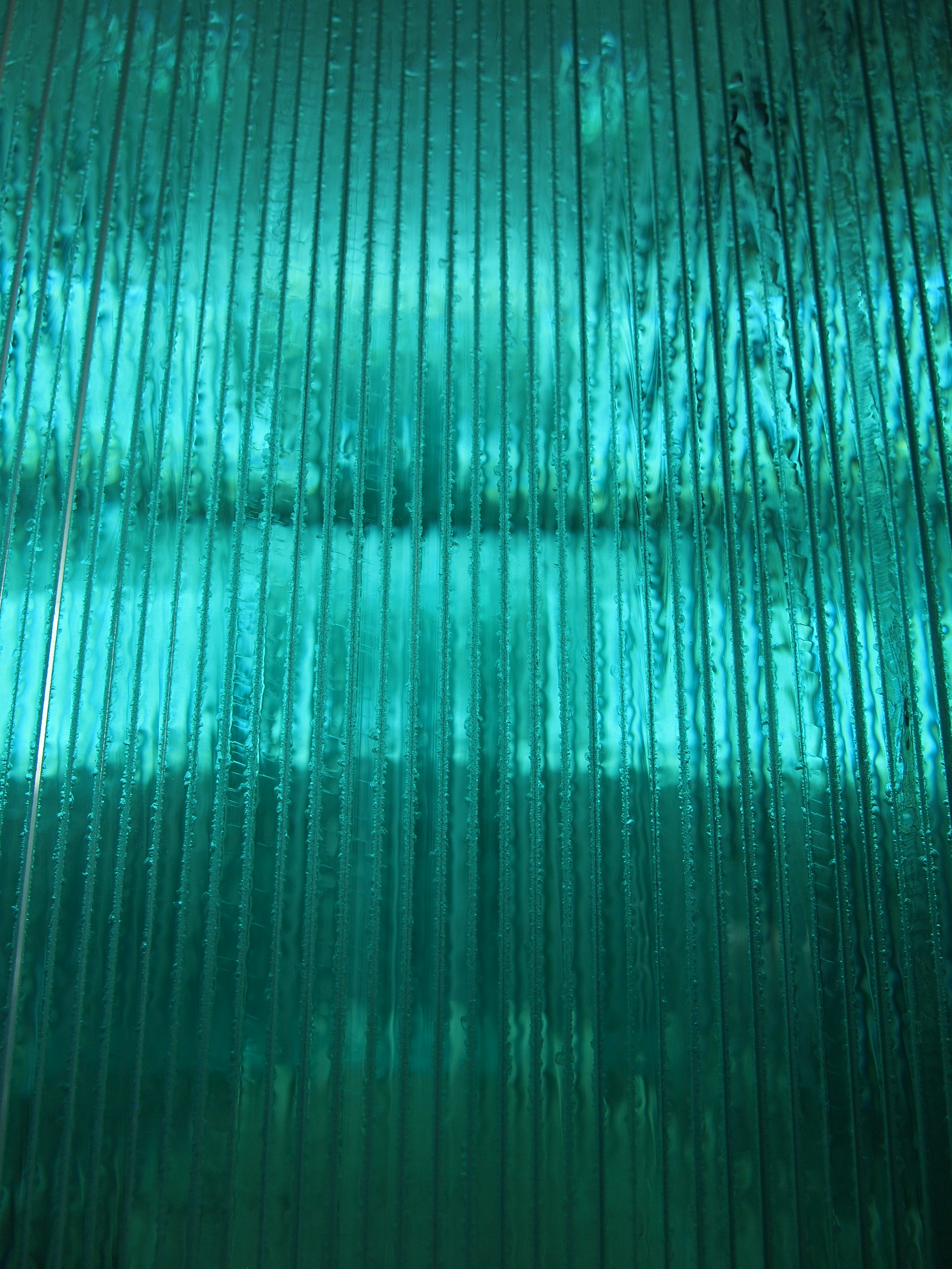 Close up of glass edges abstract teal green