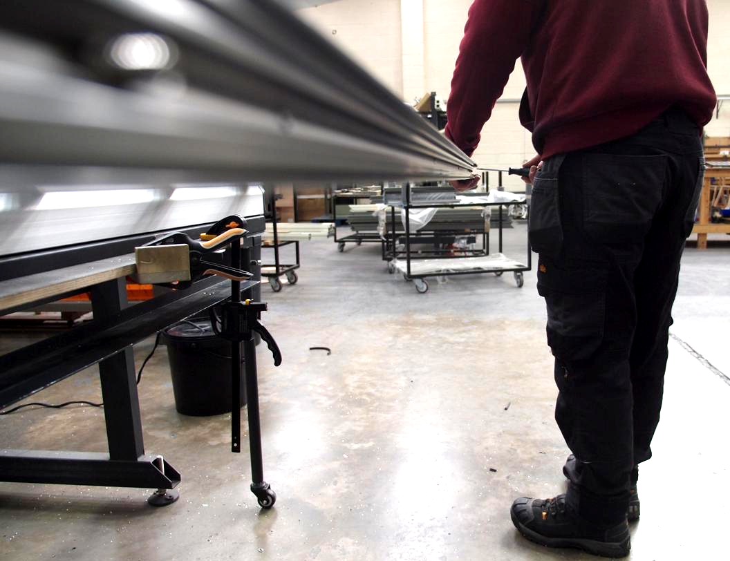 Workshop team member working at the assembly bench