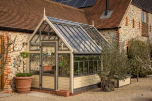 Three quarter lean to Greenhouse in mediterranean gravel garden
