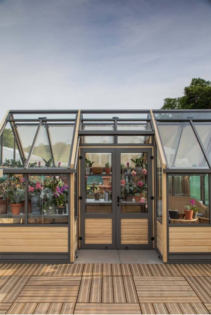 view of a large greenhouse with double doors access in the side.