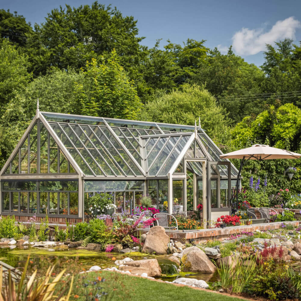 porch greenhouse on dwarf wall surrounded by plants