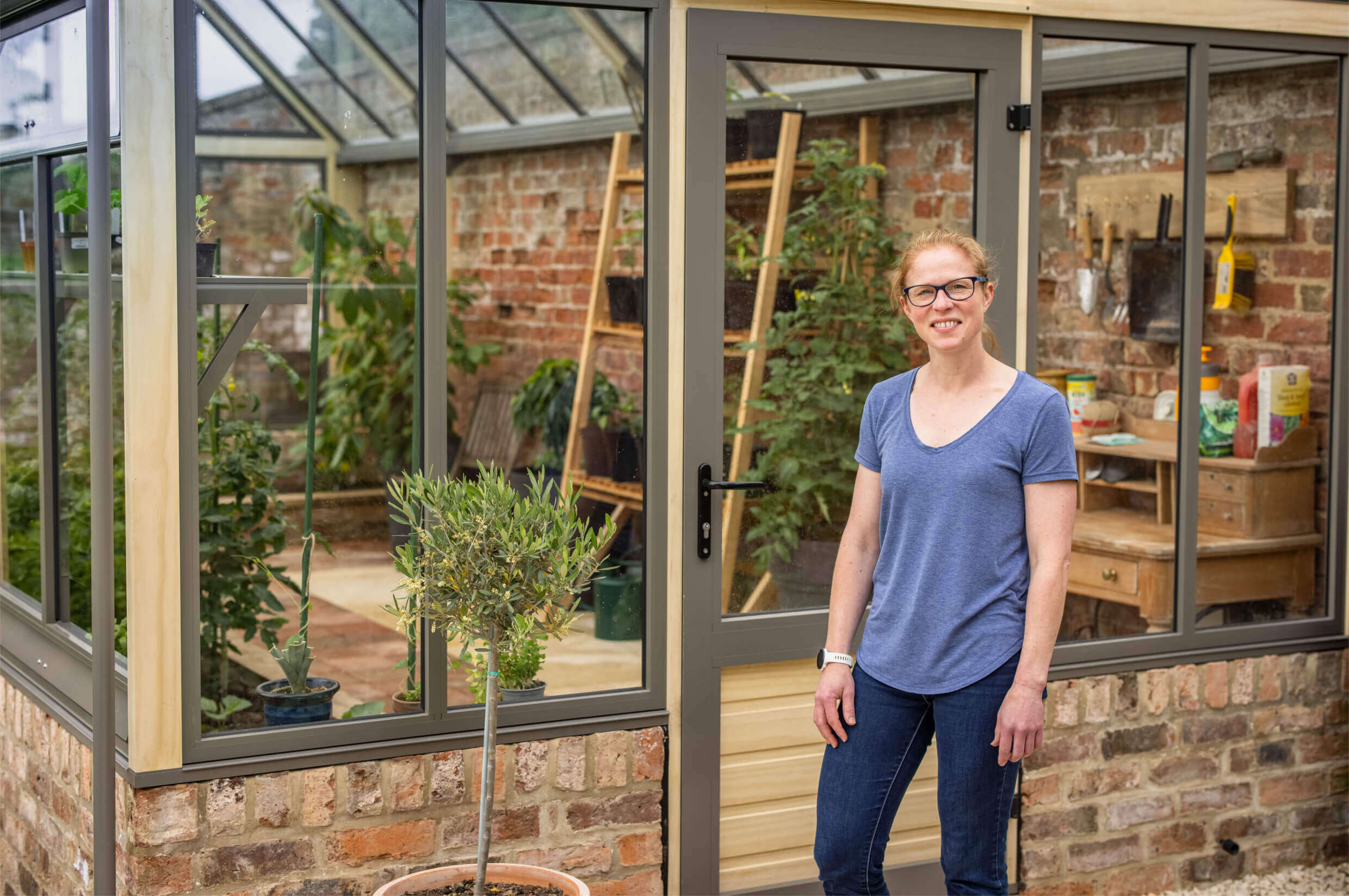 proud customer in front of cultivar greenhouse